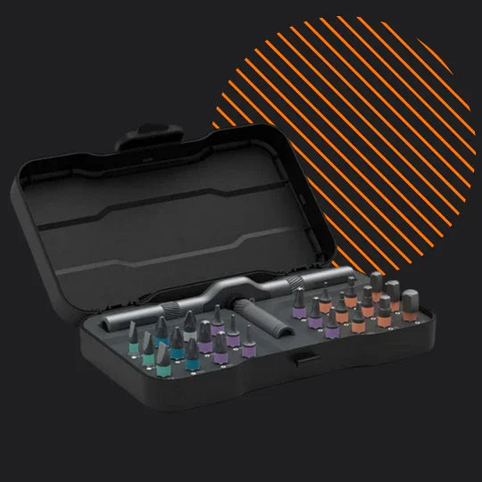 24-in-1 ratchet screwdriver set with colored bits in open black case on dark background