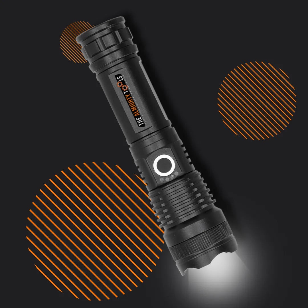 Black tactical flashlight with illuminated button, labeled The Almighty Tools, on dark background