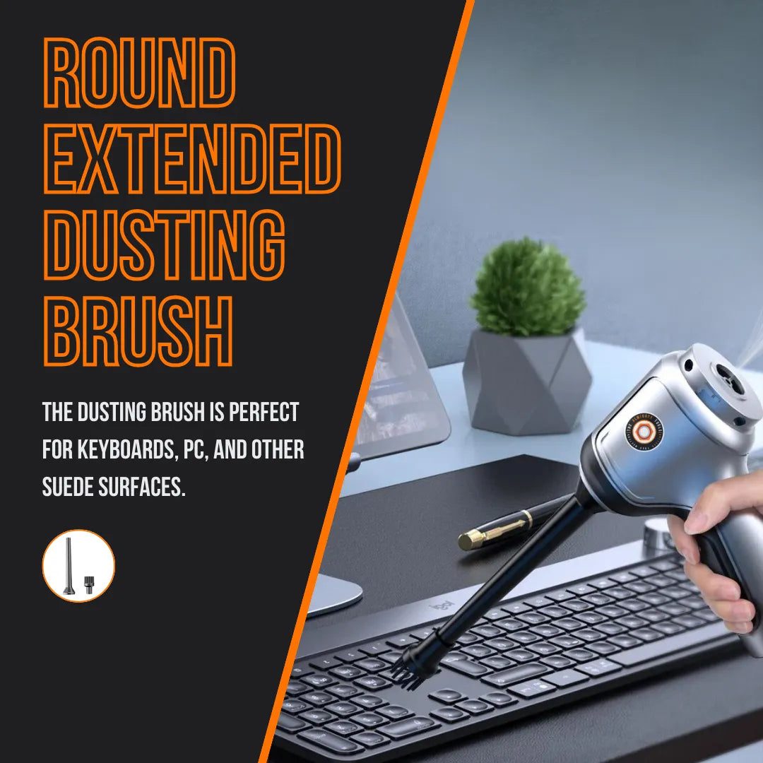 Hand using round extended dusting brush vacuum to clean keyboard on office desk
