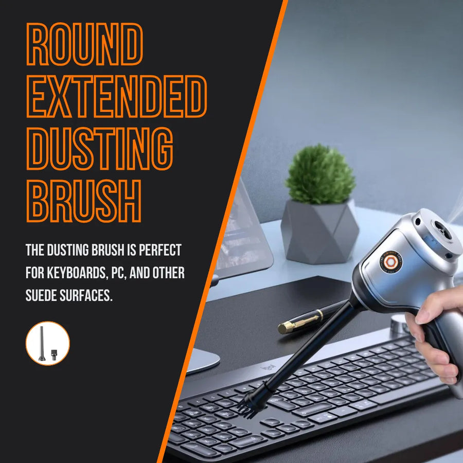 Hand using round extended dusting brush vacuum to clean keyboard on office desk