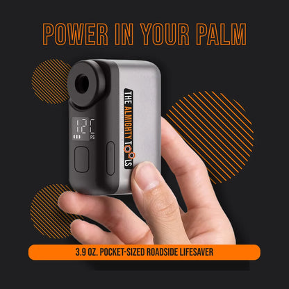 Hand holding AirBuddy 2 portable air pump, compact design with digital display, branding visible