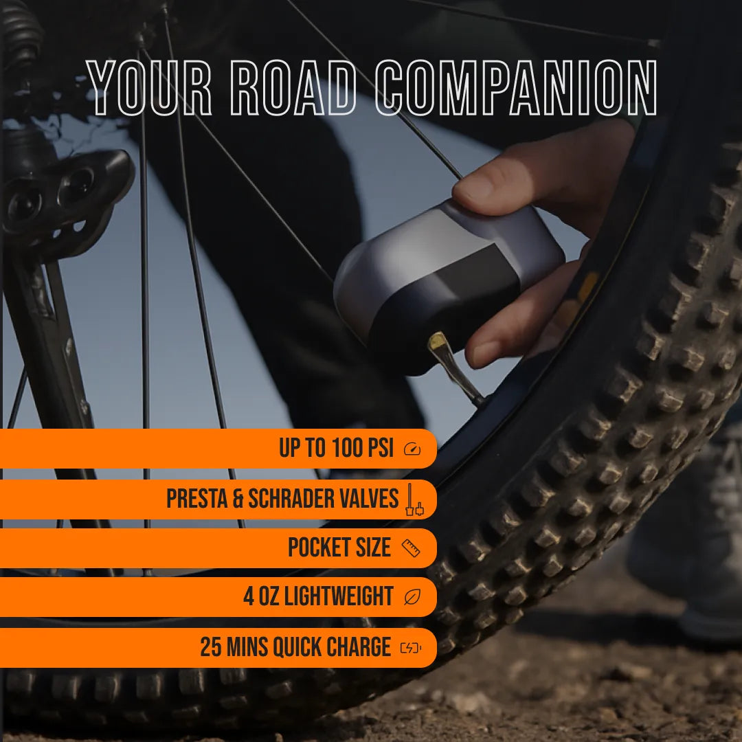 Hand using AirBuddy 3 portable bike tire inflator on mountain bike outdoors