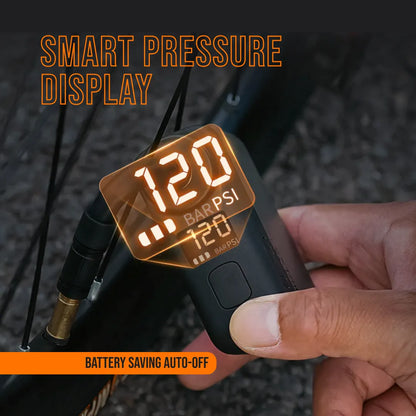 Hand using AirBuddy 5 portable air pump with smart pressure display for bike tire inflation