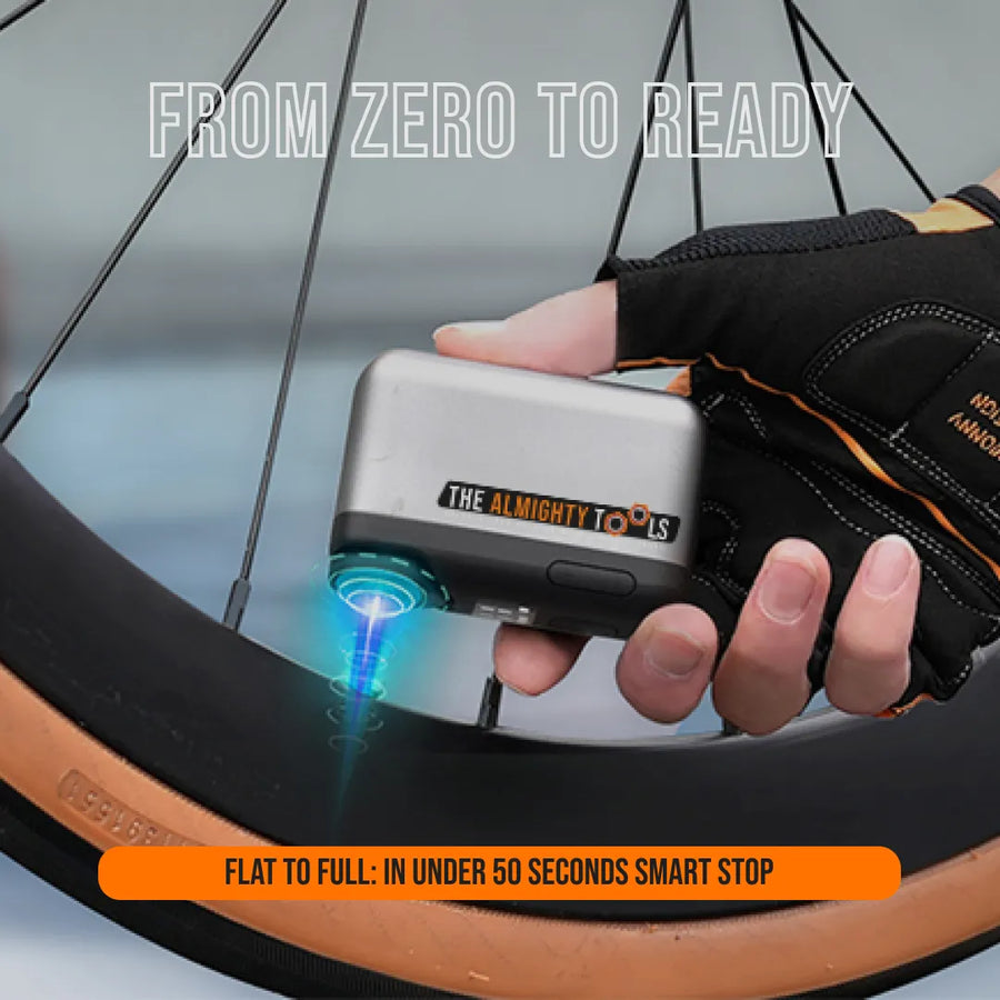 Hand using Almighty Tools AirBuddy 6 portable air pump on bicycle tire