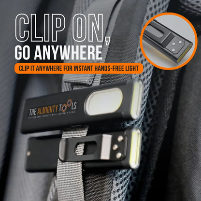 Clip-on mini LED flashlight attached to a backpack strap for hands-free lighting