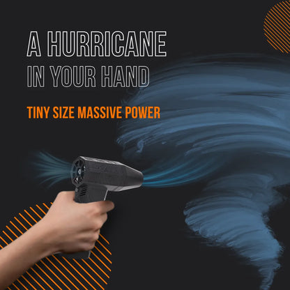 Hand holding compact black air blower with swirling blue wind, hurricane power concept