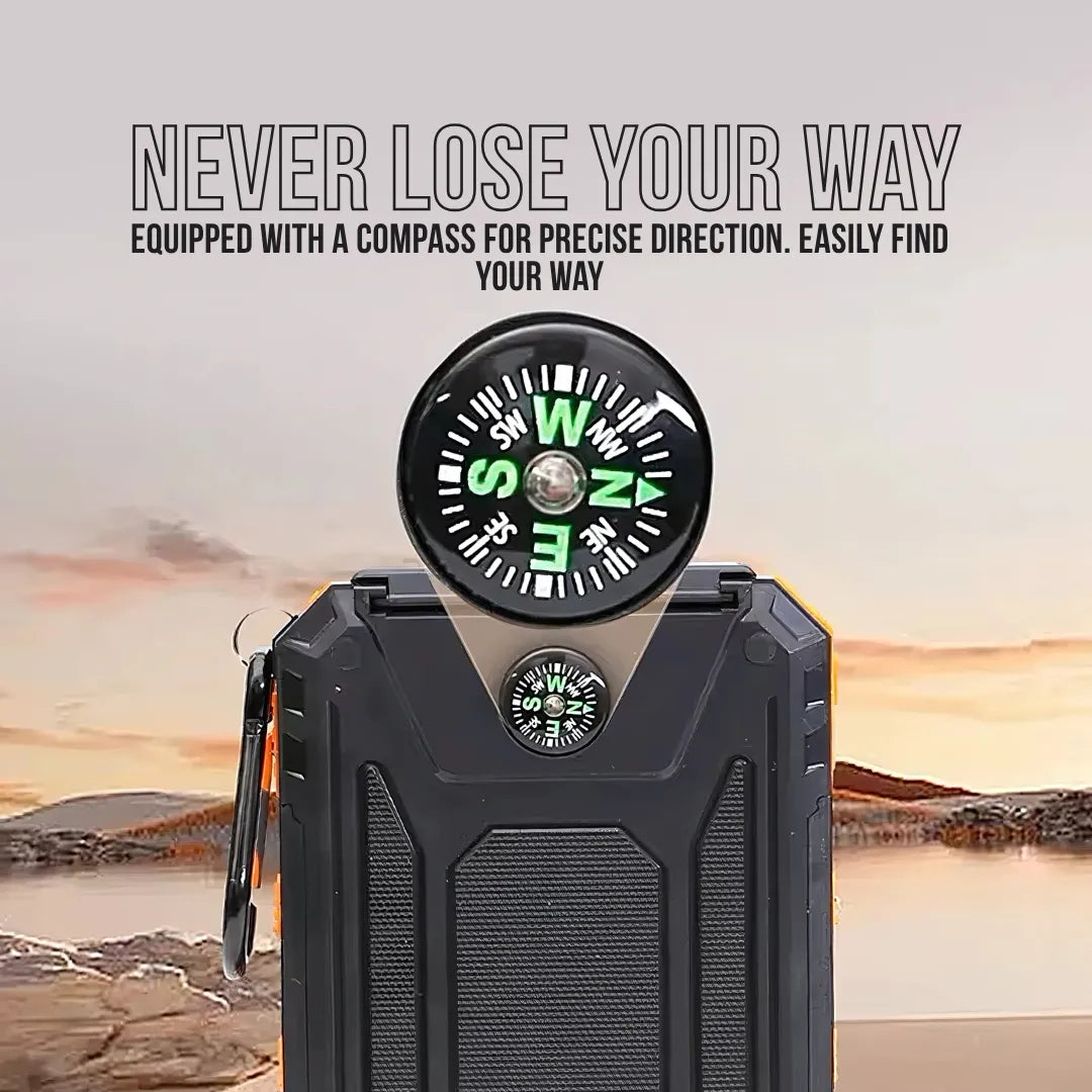 Black power bank with built-in compass, outdoor setting, sunset background