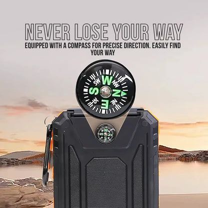 Black power bank with built-in compass, outdoor setting, sunset background