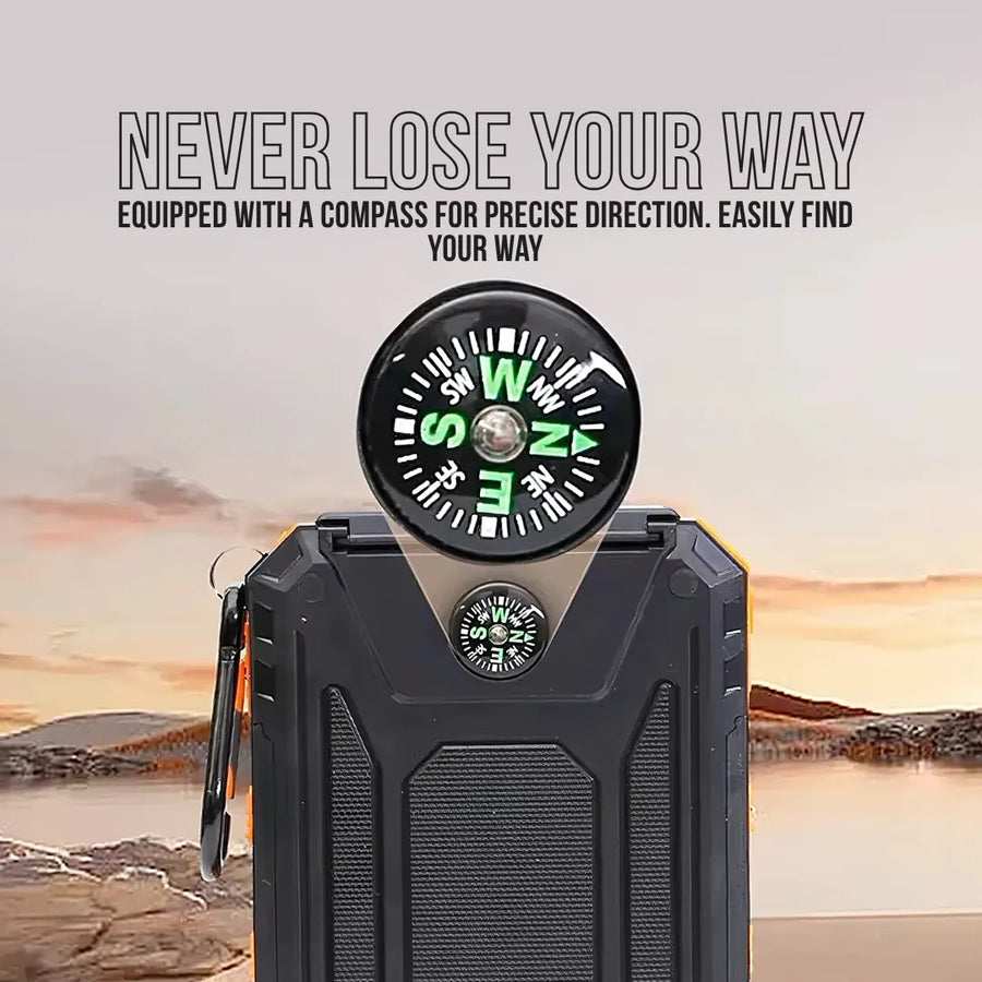 Black power bank with built-in compass, outdoor setting, sunset background